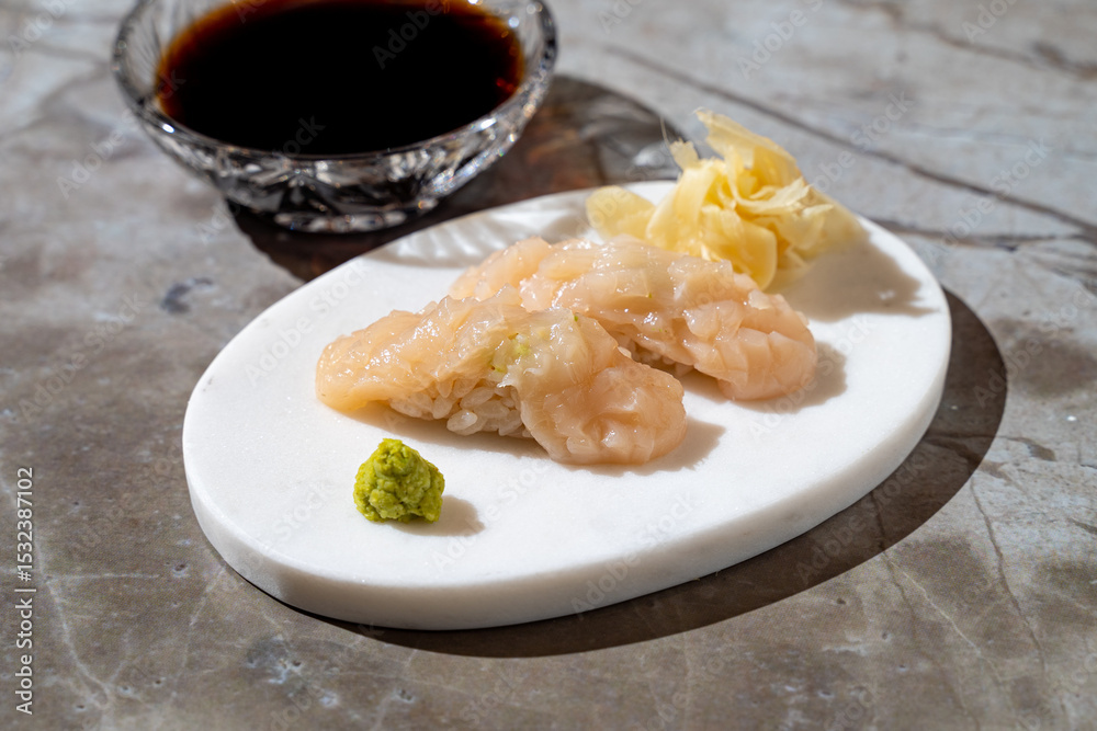Savor the artistry of seafood with finely crafted shrimp sushi, accompanied by a touch of wasabi and pickled ginger, creating a perfect balance of flavors on a textured surface Savor the artistry of seafood with finely crafted shrimp sushi, accompanied by a touch of wasabi and pickled ginger, creating a perfect balance of flavors on a textured surface