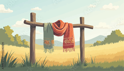 Two scarves hanging on wooden frame in grassy field landscape