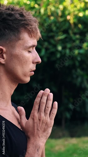 Yoga Meditation and Breathing of Handsome Man Enjoying Tranquility of Green Park. Mental Health and Mind Freedom of One Modern Yogi Inhaling Slow and Praying. Close Up Face of Guy Gesturing Namaste