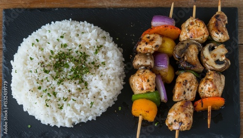 Outdoor dining is elevated with a delicious recipe for grilled chicken kebabs, featuring mushrooms and veggies, all presented on a stylish slate platter