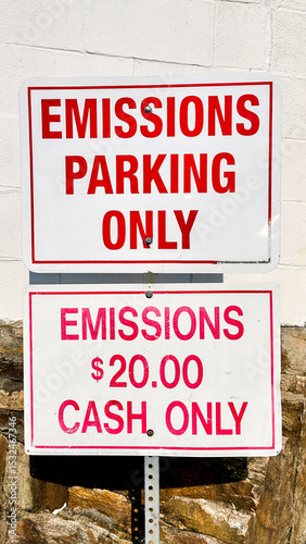 Emissions parking sign with cash payment requirement displayed outdoors