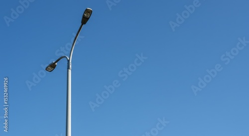 Street lamp against clear blue sky during daytime  