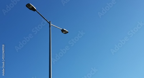 Streetlight against a clear blue sky on a sunny day  
