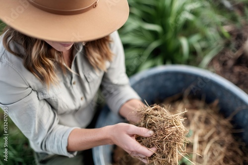 Farmer holding hay for sustainable livestock farming practices