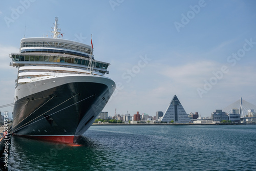 Classic ocean liner cruiseship cruise ship Elizabeth in port of Aomori, Japan with skyscraper downtown city skyline during summer Honshu circumnavigation cruising for cherry blossom bloom