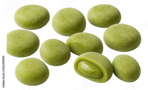 Green mochi filled with creamy matcha filling displayed in a scattered arrangement.