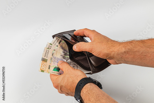 Holding a wallet with cash inside during a financial transaction