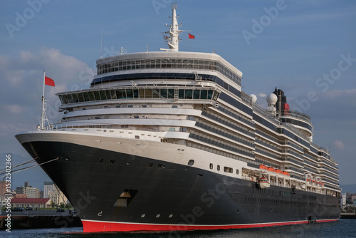 Classic ocean liner cruiseship cruise ship Elizabeth in port of Aomori, Japan with skyscraper downtown city skyline during summer Honshu circumnavigation cruising for cherry blossom bloom