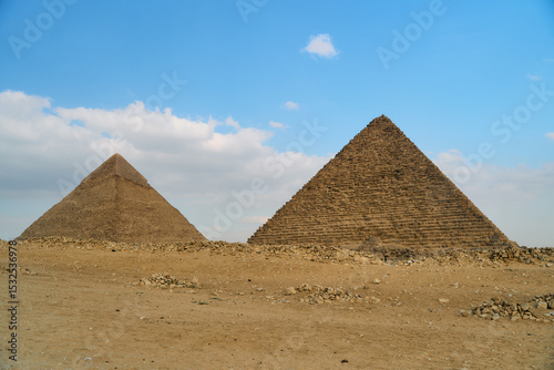 A stunning view of the majestic Giza pyramids against a cloudy sky, showcasing ancient architectures glory