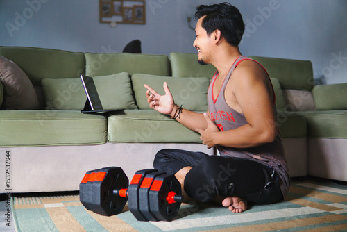 Man Engaged In Online Fitness Session With Weights In Comfortable Home Setting
