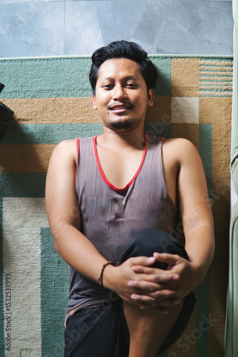 Man Practicing Leg Stretching Exercise Indoors for Fitness
