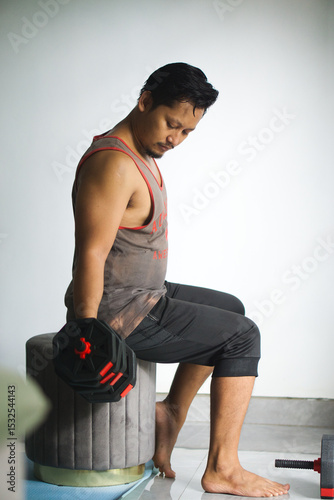 Man Exercising Indoors Lifting Dumbbells at Home for Strength and Fitness Training