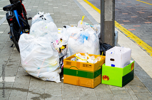 Pile of garbage on the footpath at side road in big city, pollution trash,Korea
