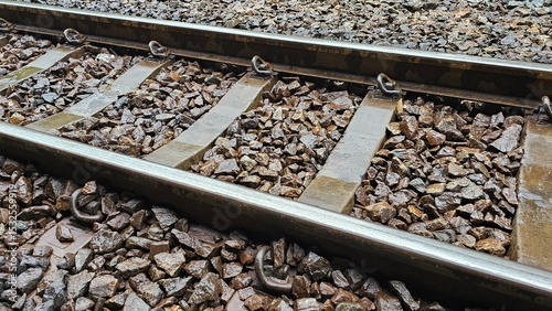 Photography Railway Tracks Close-Up: Detailed view of railway tracks, emphasizing the metal rails, ballast, and fasteners