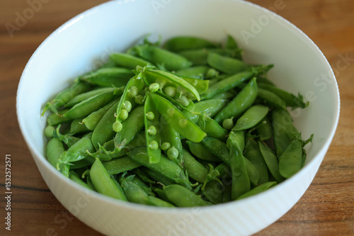 lots of peas in the plate. High quality photo