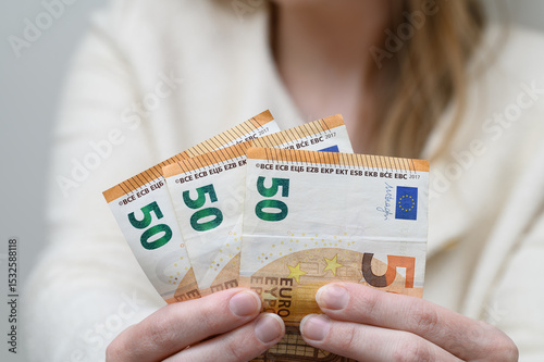woman holding banknotes in her hands. Euro currency, a fan of money