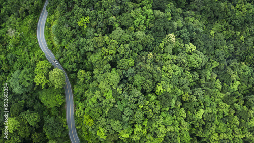 Electric cars to protect the environment and transportation road of Top view road in beautiful Rain forest with natural background, landscape view from flying drone in Nature