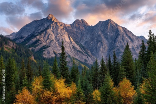 Majestic mountain range at sunset with autumnal forest