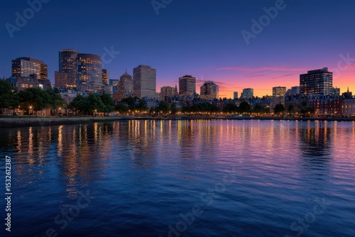 City skyline view at dusk reflecting in the water with colorful sky above it all