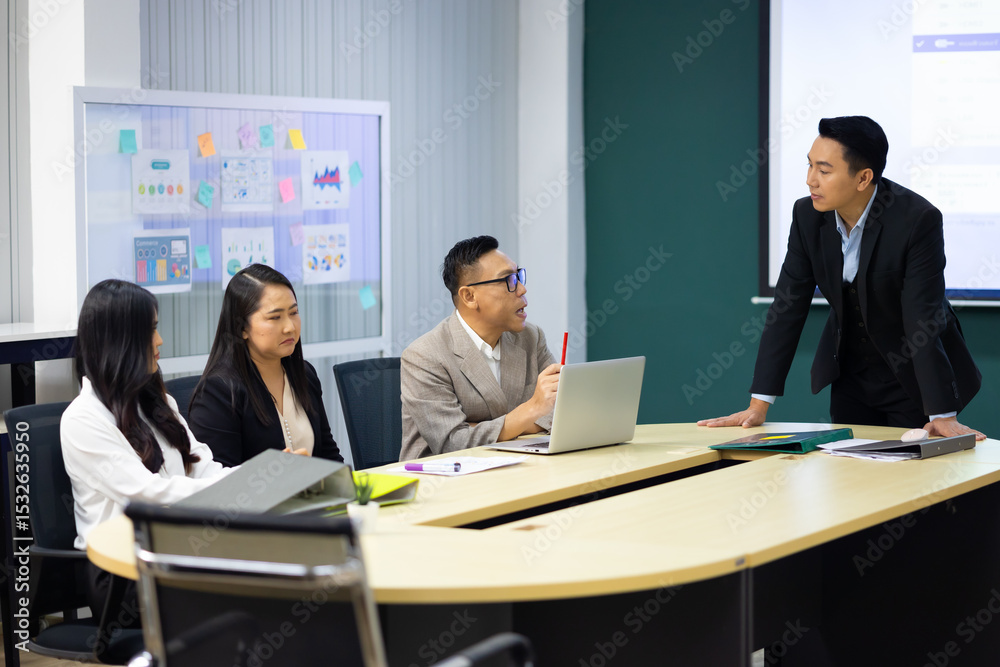 Fototapeta premium Presentation - Asian business man people giving presentation and Report pointing at projector screen. People Work in Business Office.