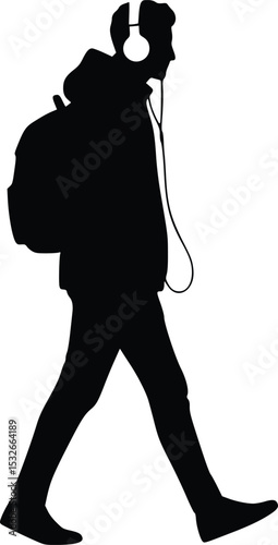 Silhouette of a person wearing headphones, carrying a backpack, walking with raised arm