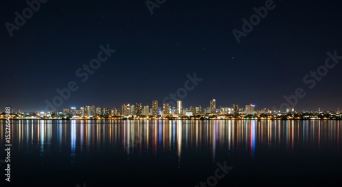 Night city skyline reflected in water