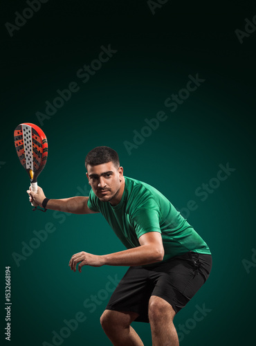 Padel player holding racket on green background, perfect for tournament ads, training promotions, or sports gear campaigns on social media.