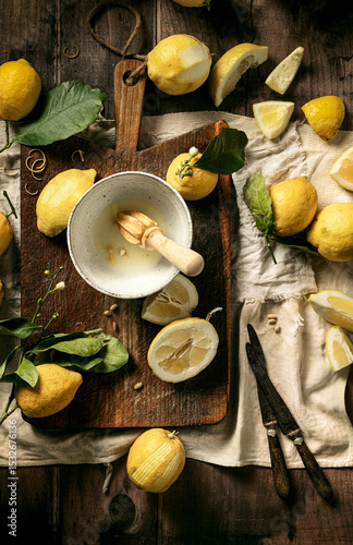 fresh lemons just squeezed on wooden board with leaves