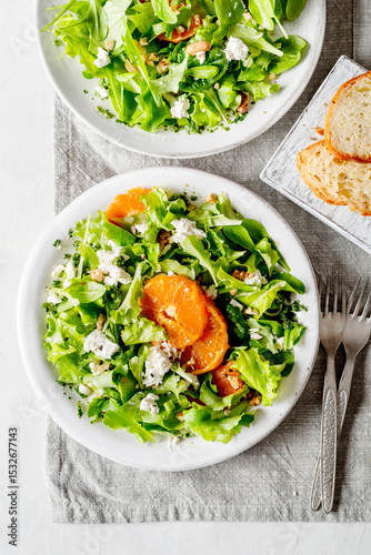 A light appetizer or an elegant side dish. Salad prepared with a mix of different varieties of leaves, enriched with orange slices, walnuts and pieces of cheese, feta, with a delicate flavor.
