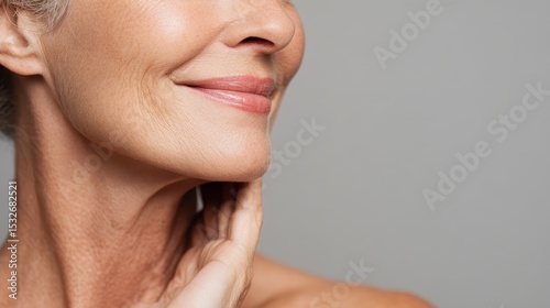 Senior woman softly caressing neck, revealing natural skin texture and graceful aging process, embodying confidence and self love