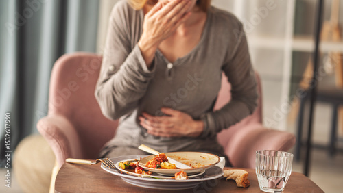 Woman with bloating and stomach pain after eating