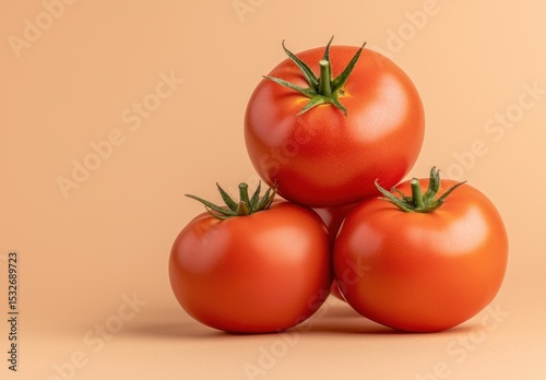 Fresh Red Tomatoes Stacked on a Soft Peach Background for Culinary and Kitchen Use in Stock Photography