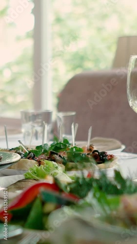 Catering service on banquet table with canape snacks in restaurant or hotel. Decorated food set on birthday, wedding celebration or business conference event venue.