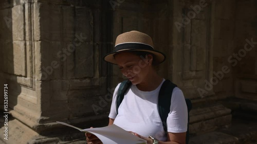 Happy Woman Tourist Explores an Old Medieval City with a Map, Delighting in the Discovery of Historic Landmarks and Beautiful Architecture During Her Solo Travel Adventure.