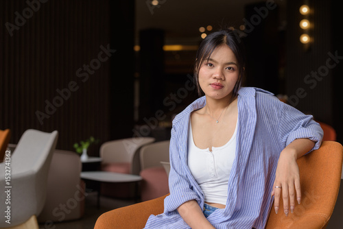 Free Download young woman sitting in a cafe - GFXLoad