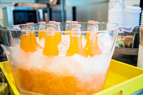 orange bottles or cocktail on ice