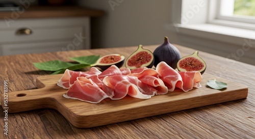A wooden board of presunto with figs on a kitchen table