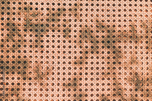 Rattan texture pattern with sunlight shadow from above. Summer beach aesthetic background. Natural minimal outdoor fashion design.