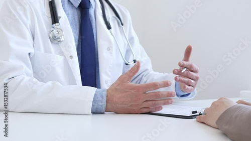 Doctor gesturing with hands while explaining diagnosis to patient during medical consultation in hospital office, healthcare and medical concept. Medicine