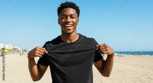 Man showing blank t-shirt on beach
