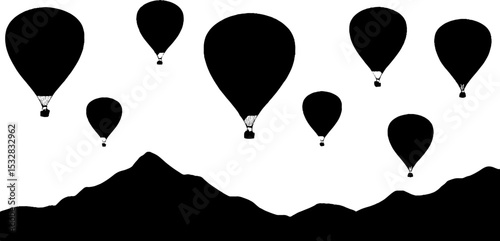 Hot air balloons silhouette against high contrast mountainous border