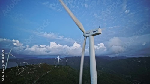 Experiencing evening sunset at jiangmen windmill hill with wind turbines silhouetted against the dusk sky