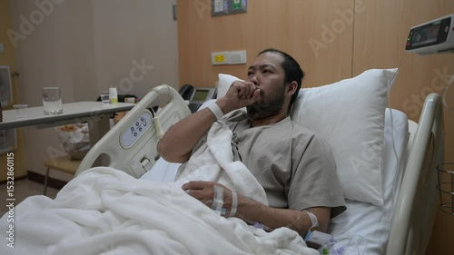 Asian man is sick and is being treated at the hospital,Waiting for the doctor to give intravenous medication,A nurse came to take my temperature and measure my blood pressure.