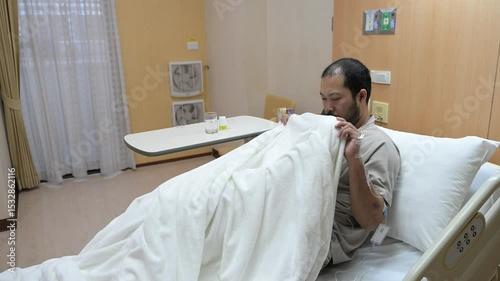 Asian man is sick and is being treated at the hospital,Waiting for the doctor to give intravenous medication,A nurse came to take my temperature and measure my blood pressure.