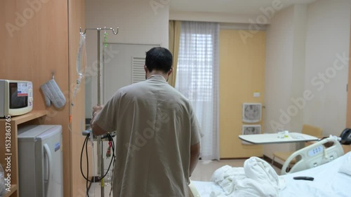 Asian man is sick and is being treated at the hospital,Waiting for the doctor to give intravenous medication,A nurse came to take my temperature and measure my blood pressure.