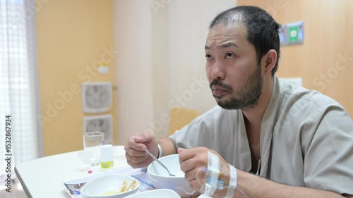 Asian man is sick and is being treated at the hospital,Waiting for the doctor to give intravenous medication,A nurse came to take my temperature and measure my blood pressure.
