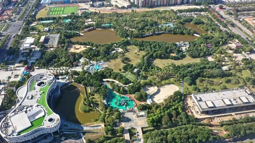 Aerial perspective of Guangzhou Baiyun New City Green New City, featuring parks, lakes, buildings, and green spaces on a sunny day in China