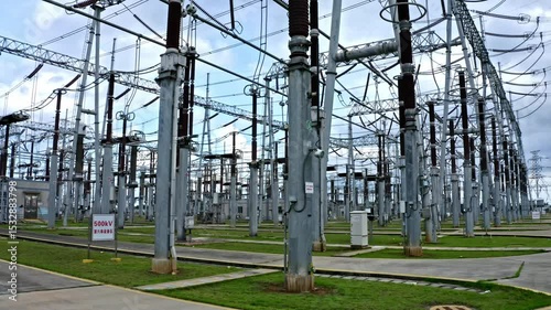 Zhanjiang Southern Power Grid substation reveals intricate network of power lines and equipment at a daytime outdoor facility