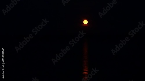 Red strawberry moon rises over the Greifswalder Bodden in June 2025. Mystical glow reflects on the water.  The video excerpt of 17 seconds is 85 MB in size. The frame rate is 50 pps.