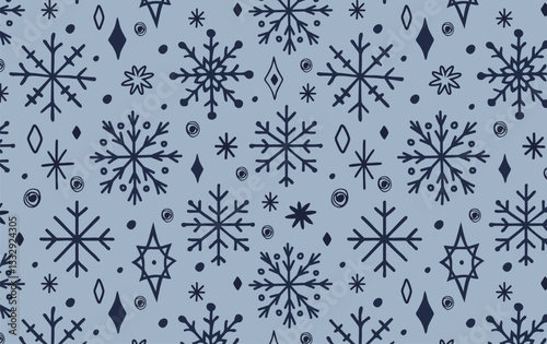 Seamless hand-drawn snowflakes pattern with winter decorative elements on dusty blue background. Modern Scandinavian Christmas design, perfect for gift wrap, packaging, textile, wallpapers, and holida